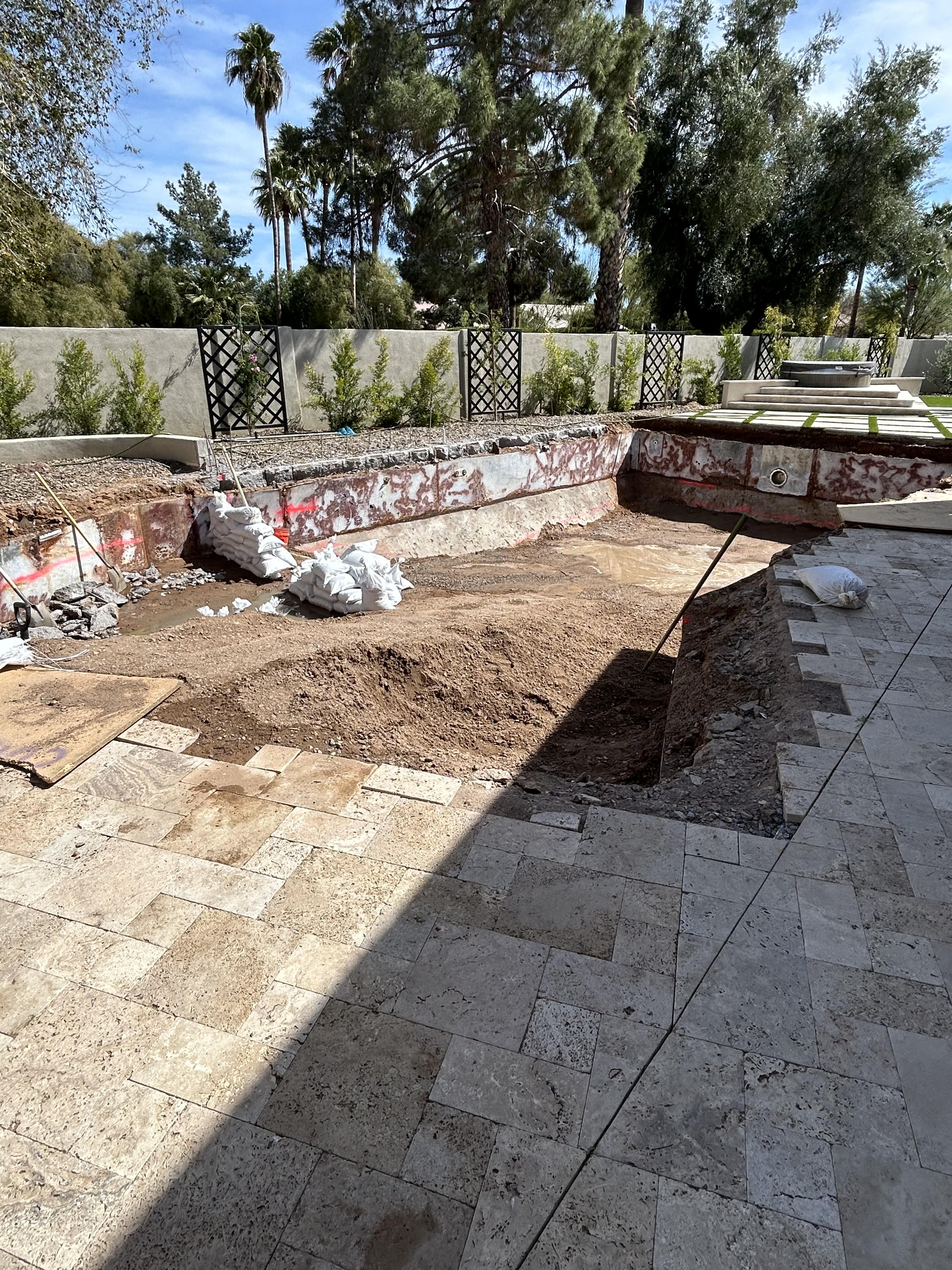 Pool remodel in progress showing demolition of old shell with exposed rebar in Surprise, Arizona